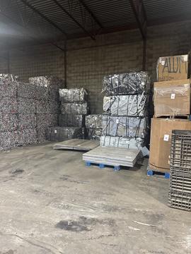 Scrap Metal Bales Ready for Recycling in Warehouse