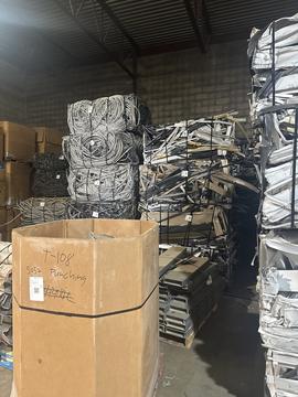 Scrap Metal Recycling Facility with Stacked Materials and Cardboard Bins